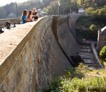 Drei junge Frauen blicken von der Diemelsee-Staumauer hinunter
