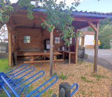 Eine ueberdachte Sitzgelegenheit, an der man Getraenke und Suesses in Selbstbedienung erwerben kann 