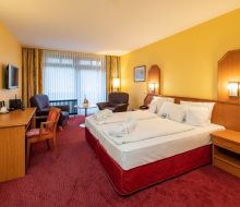 Doppelzimmer mit Doppelbett und Sitzgelegenheit 